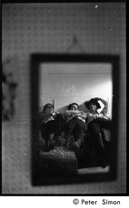 Boston University News staff: Stephen Davis, Joe Pilati, and Clif Garboden (r. to l.) reflected in a mirror, lying back