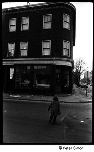 Young girl crossing Columbia Street, near intersection with Harvard St., Cambridge, Mass.