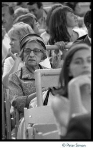 Elderly woman seated among Beatles fans during concert at Shea Stadium