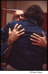 Ram Dass embracing a man after a lecture at Boston University