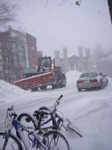 Snowplow with automobile and snow bound bicycles, on Main Street, Northampton, Mass.