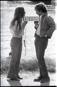 Lacey Mason and Elliot Blinder holding stereo equipment