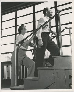 Physical therapist assisting man on stairs