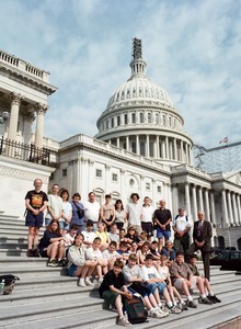 Congressman John W. Olver with group of visitors, posed on the steps of the United States Capitol building