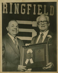 President Locklin giving Springfield College Athletic Hall of Fame award to Charles E. Silvia