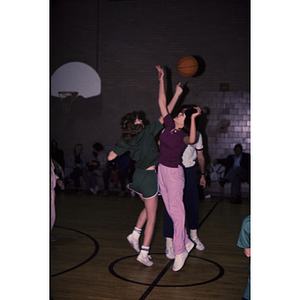 Young women playing basketball