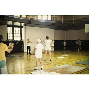 Group of people in a gym holding dumbbells