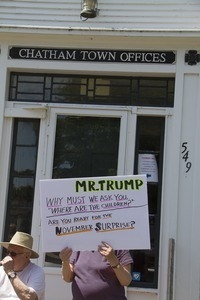 Pro-immigration protester in front of the Chatham town offices building with a sign imploring Trump 'Why must we ask you where are the children': taken at the 'Families Belong Together' protest against the Trump administration’s immigration policies