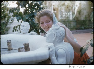 Joanna Simon posing with gargoyles on a fountain