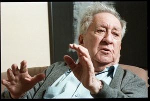 Fine art photographer Aaron Siskind: close-up portrait, seated in a armchair in his living room