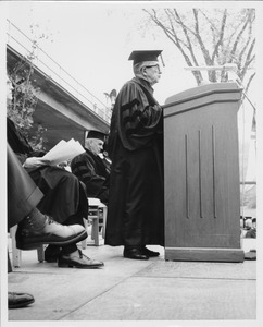 Frank L. Boyden in academic robes speaking at podium