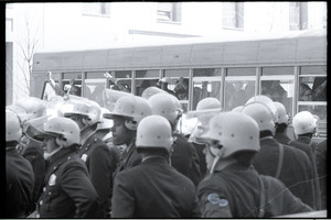 May Day demonstrations and street actions by the Justice Department: line of police in front of bus carrying off arrester protesters