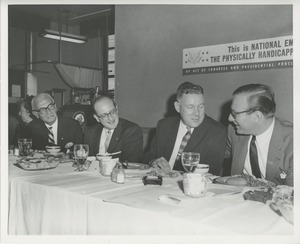 Willis C. Gorthy eating dinner during national employ the physically handicapped (neph) week