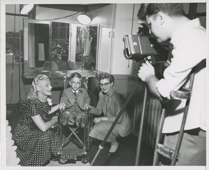 Boy in wheelchair and women take photo