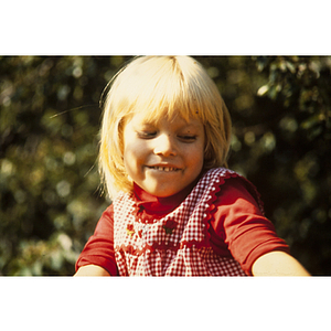 Child in red smiling