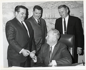 Mayor John Collins giving an unidentified man a key