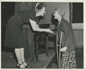 Two women shaking hands