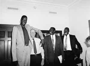 Congressman John W. Olver with Manute Bol (left) towering over him, and other visitors