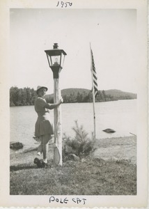 Bernice Kahn posing with a lamp post in front of a lake
