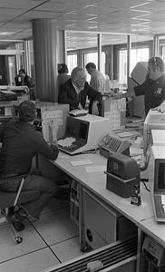 Mayor Kevin White, unidentified men and police officer smiling in Boston Police Dispatch Operations Center