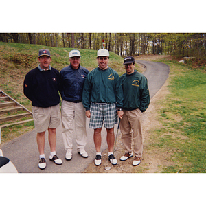 A four-man golf team standing on a cart path at the Charlestown Boys & Girls Club Annual Golf Tournament