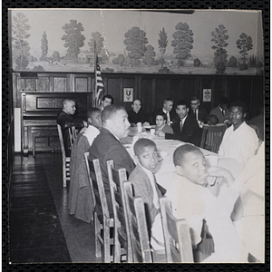 Men and boys sit a table at a Dad's Club banquet