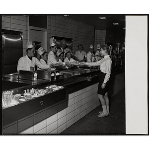 Members of the Tom Pappas Chefs' Club serve a diner in a Howard Jonhson's as Boys' Club of Boston Executive Director Arthur T. Burger (center, back row) looks on
