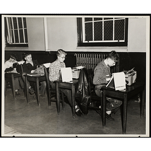 Four boys participate in a typewriting class held in the South Boston Clubhouse