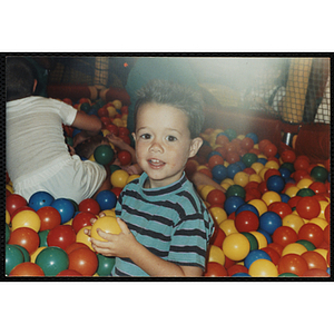 A boy poses in a Chuck E. Cheese's playground