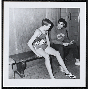 Two runners talk as they sit on a bench during the Roxbury Road Race