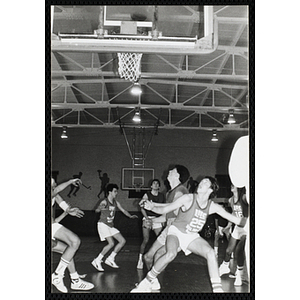 Players jockey for a rebound during a basketball game