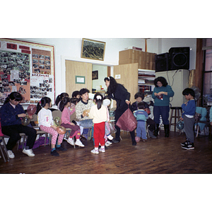 Women and children attend a holiday party hosted by the Chinese Progressive Association