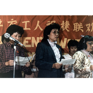 Garment workers speaking onstage