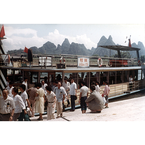Association members gather outside of a ferry boat while visiting Guilin