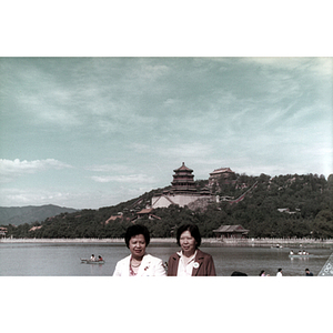 Women stand in front of a large body of water in China