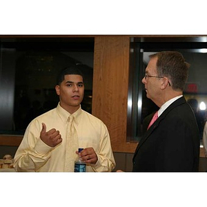 Danny Vazquez converses with William Bartolini at the Torch Scholars dinner