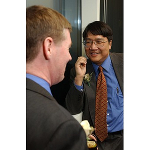 Unidentified man and Dr. Homer H. Pien speak at The National Council Dinner