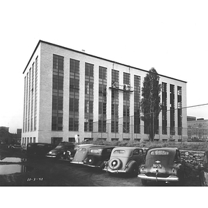 Cars parked in front of Mugar Life Sciences Building which is nearly complete