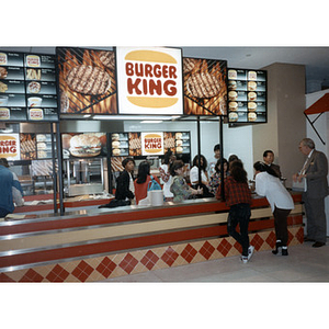 Students at the Pizza Hut stand in the food court of the Curry Student Center