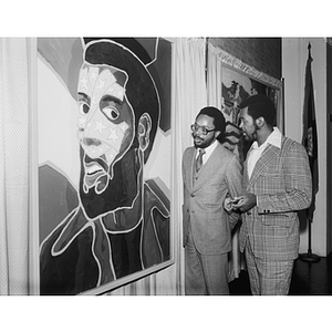 Two men examine a piece at the Dana Chandler Exhibit