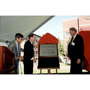 Robert Shillman reads the Shillman Hall dedication plaque after it's unveiled