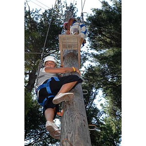 Nadia Alvarez climbs up the Torch Scholars Project Adventure Ropes Course