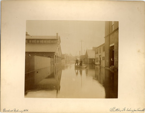 Two men using wooden crates as rafts during a flood, Roxbury, Mass., 1886