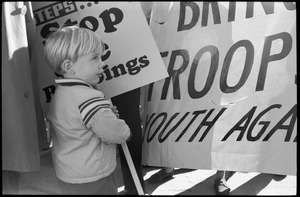 Protesters marching against the war in Vietnam: a young child carrying an anti-war sign: Washington Vietnam March for Peace