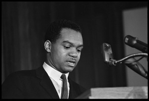 Walter E. Fauntroy speaking at a podium at the Youth, Non-Violence, and Social Change conference, Howard University