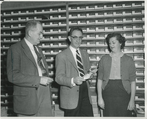 David Lipshires (center) in one of his shoe stores, with Alcide Dragon and Mrs. Teresa O'Neill