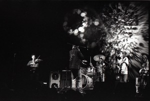 Hot Tuna concert: Band in performance on stage: Papa John Creach (violin), Will Scarlett (harmonica), Jorma Kaukonen (guitar), Jack Casady (bass) playing in front of light show