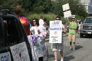 Parader marcher with a sign reading 'Just (about) married, August 21, 2009' : Provincetown Carnival parade