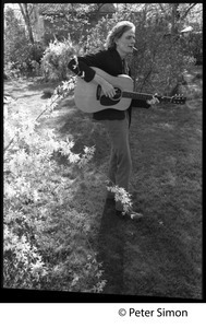 Livingston Taylor, walking through the garden, strumming a guitar
