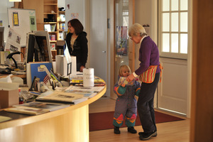 Librarian with parent and child at the reception desk, New Salem Public Library